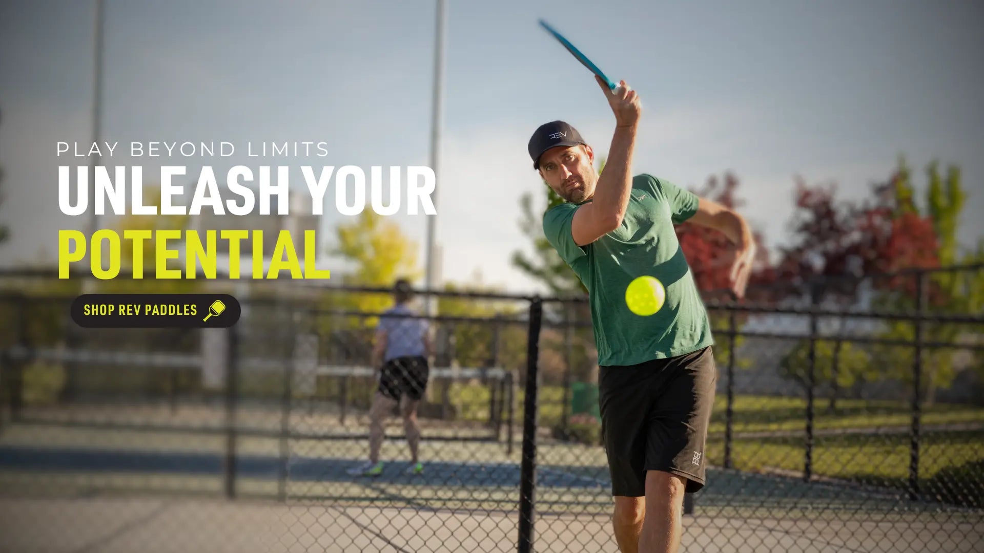 Shop REV Paddles button with pickleball players on court background